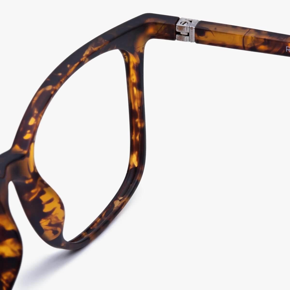 Close-up of tortoise shell eyeglasses with metal hinge