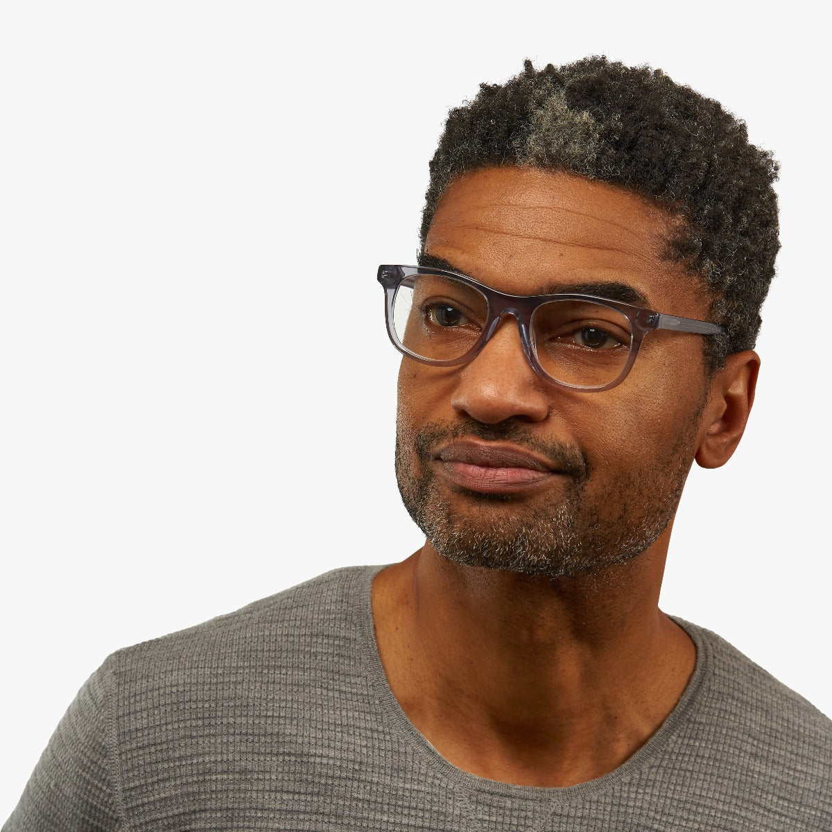 Person wearing Malmö Crystal Grey reading glasses