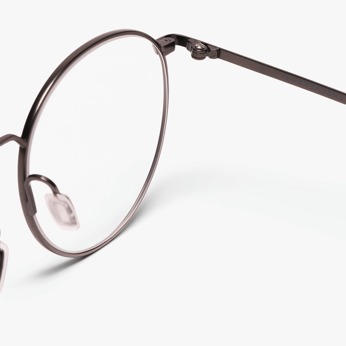 Close-up of round metal frame glasses with Luxreaders branding
