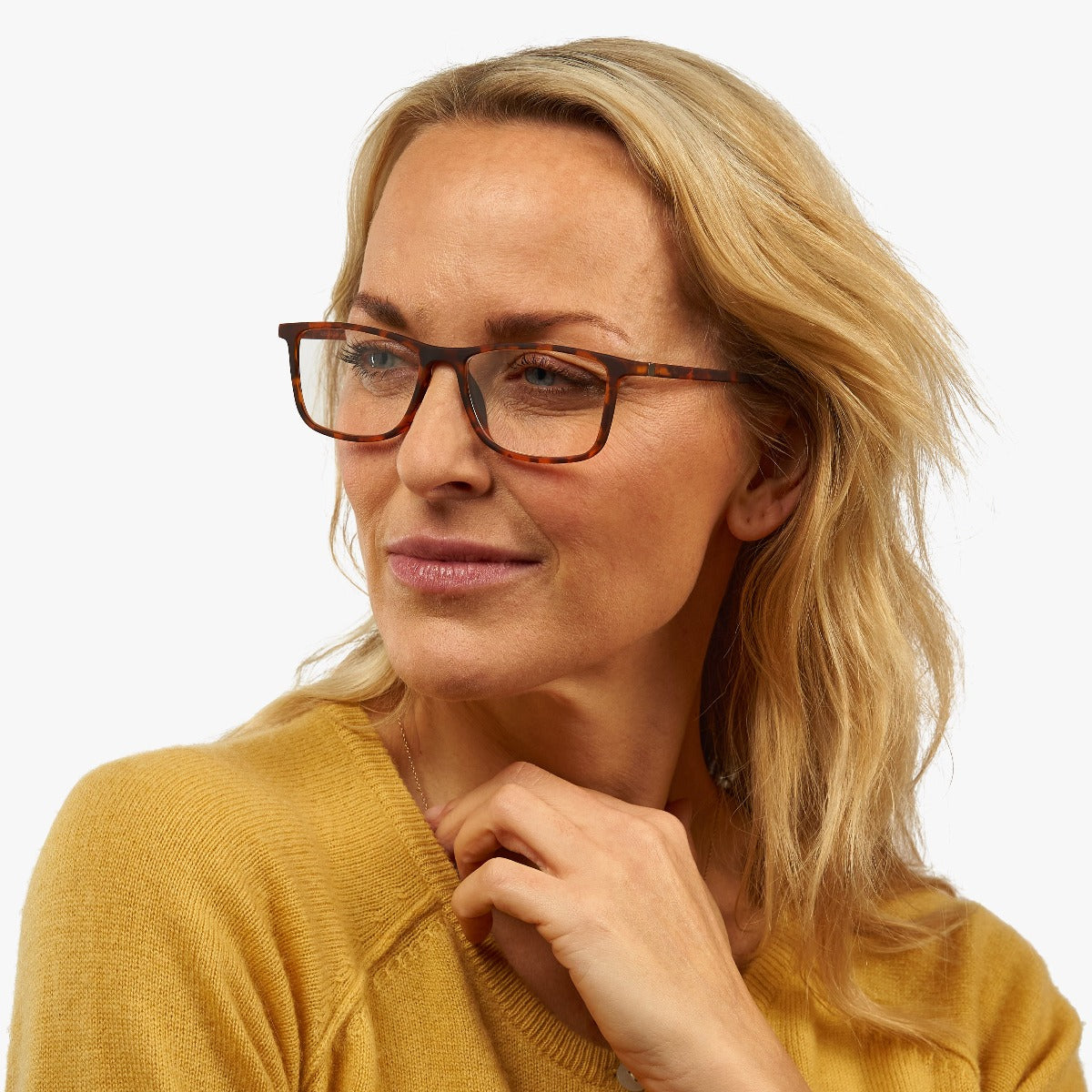 Person wearing tortoiseshell square glasses