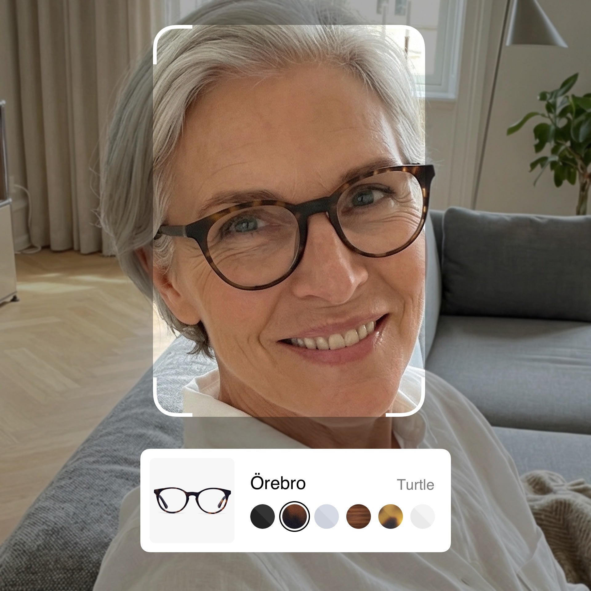 Woman wearing Örebro glasses by Luxreaders, smiling indoors, with product color options displayed.