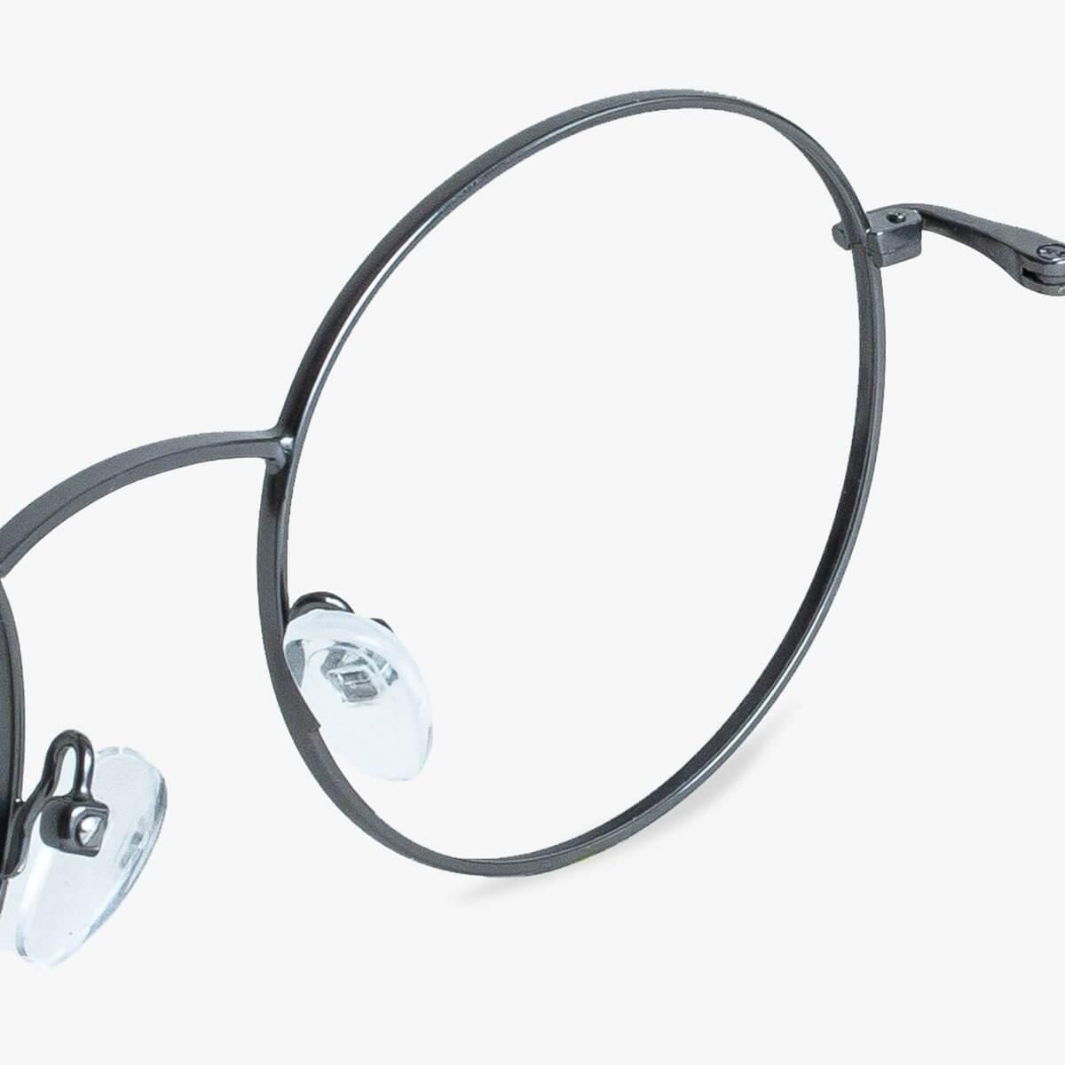 Close-up of round gunmetal glasses with adjustable nose pads